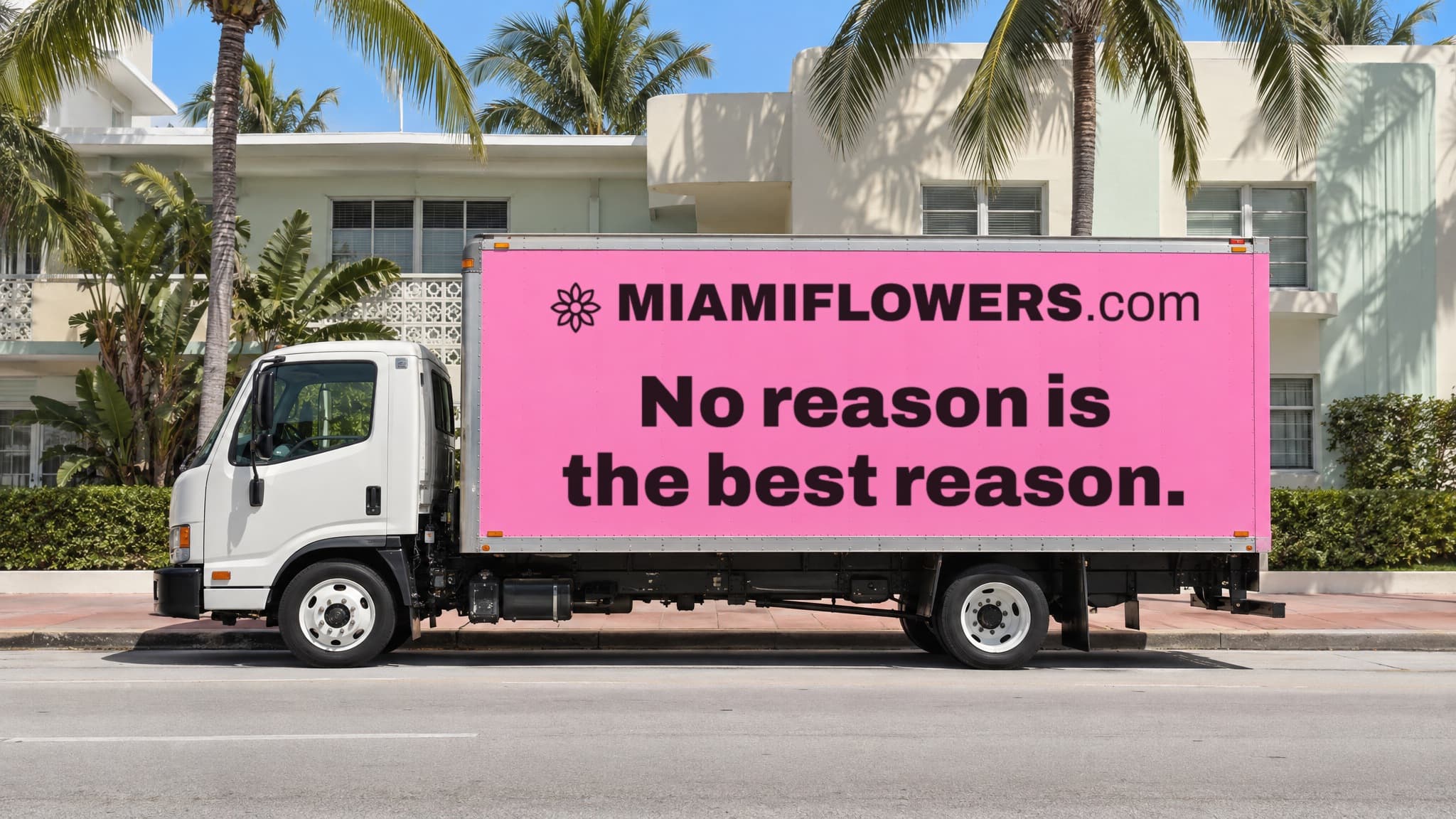 Pink MIAMIFLOWERS.com box truck on Biscayne reading 'No reason is the best reason.'