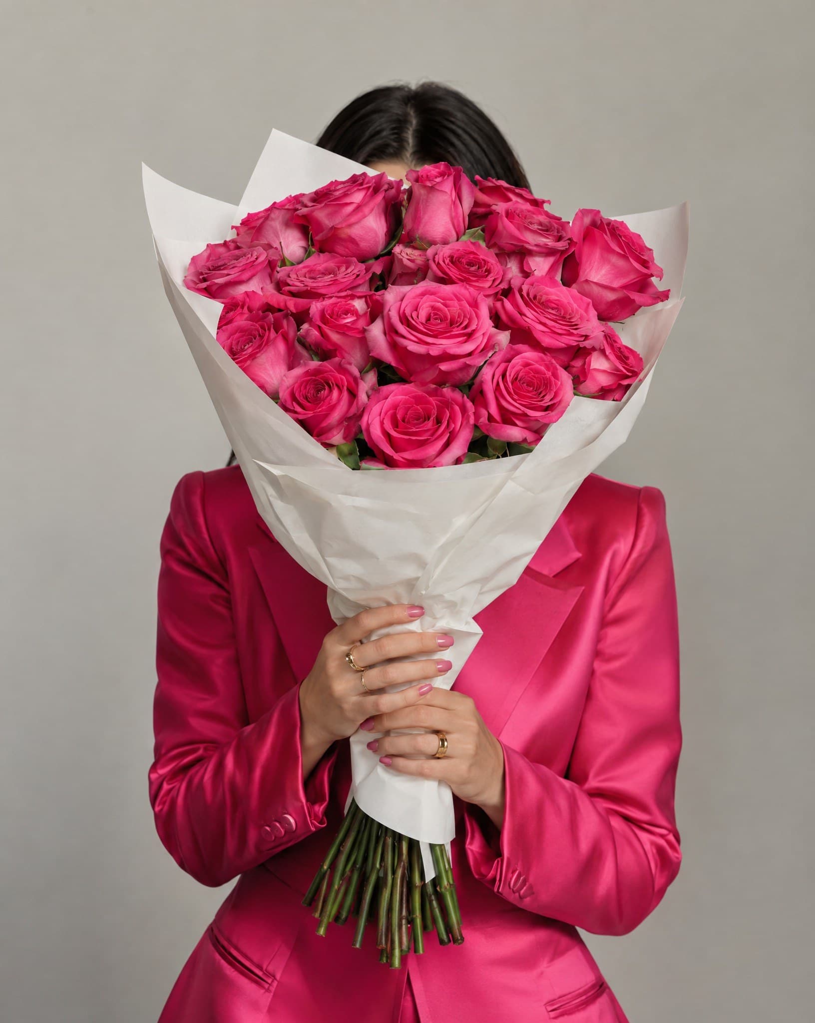 She holds the roses up to her face