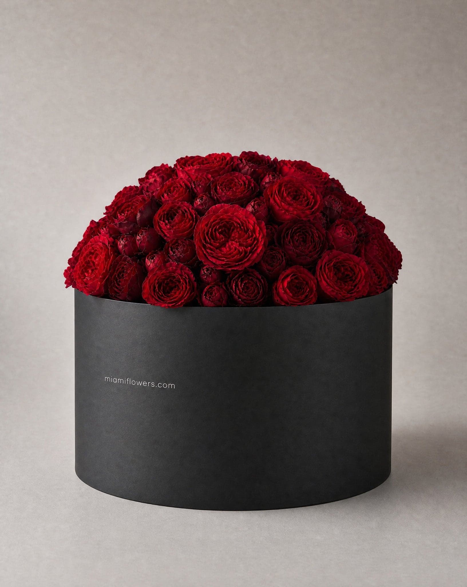 Roses in an oval box printed with miamiflowers.com