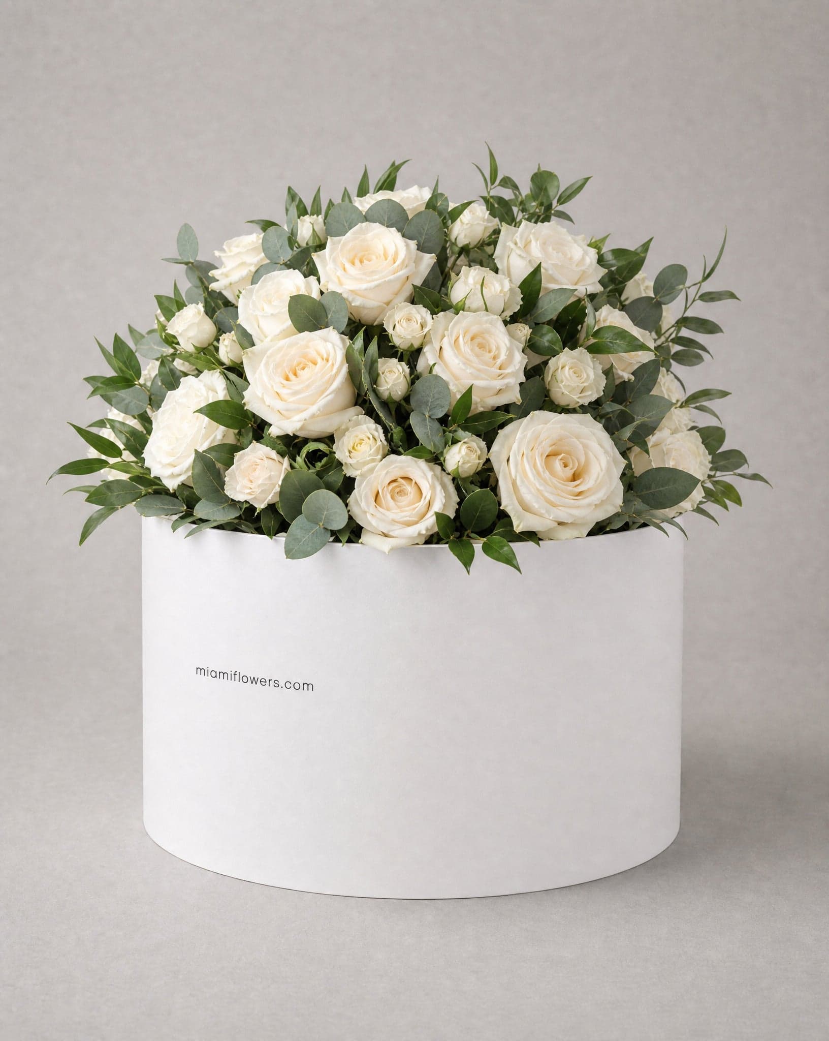 Roses in an oval box printed with miamiflowers.com